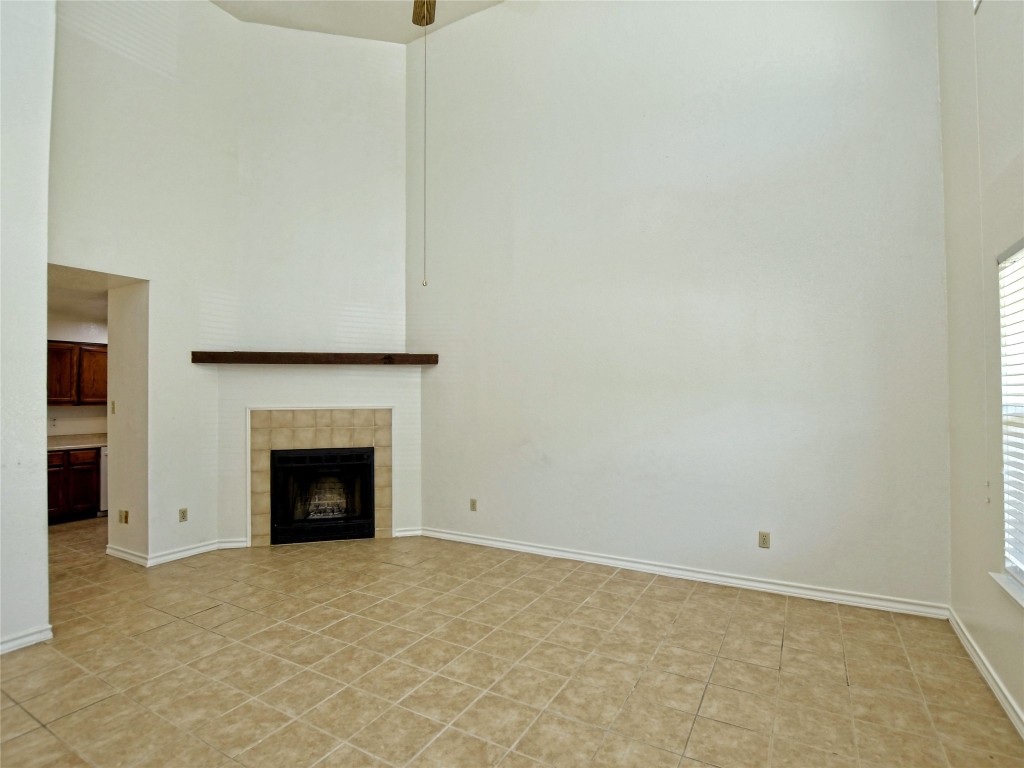 803 Valley View Drive, Unit B Pflugerville, TX 78660 - Photo 4 of 22 a view of an empty room with a fireplace and a window