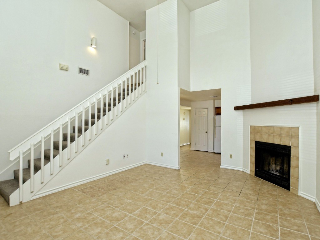 803 Valley View Drive, Unit B Pflugerville, TX 78660 - Photo 5 of 22 a view of an empty room with staircase and a fireplace