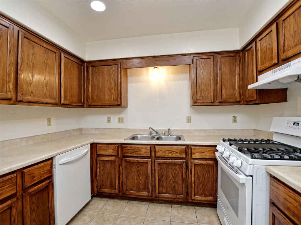 803 Valley View Drive, Unit B Pflugerville, TX 78660 - Photo 10 of 22 a kitchen with stainless steel appliances granite countertop a sink stove and cabinets