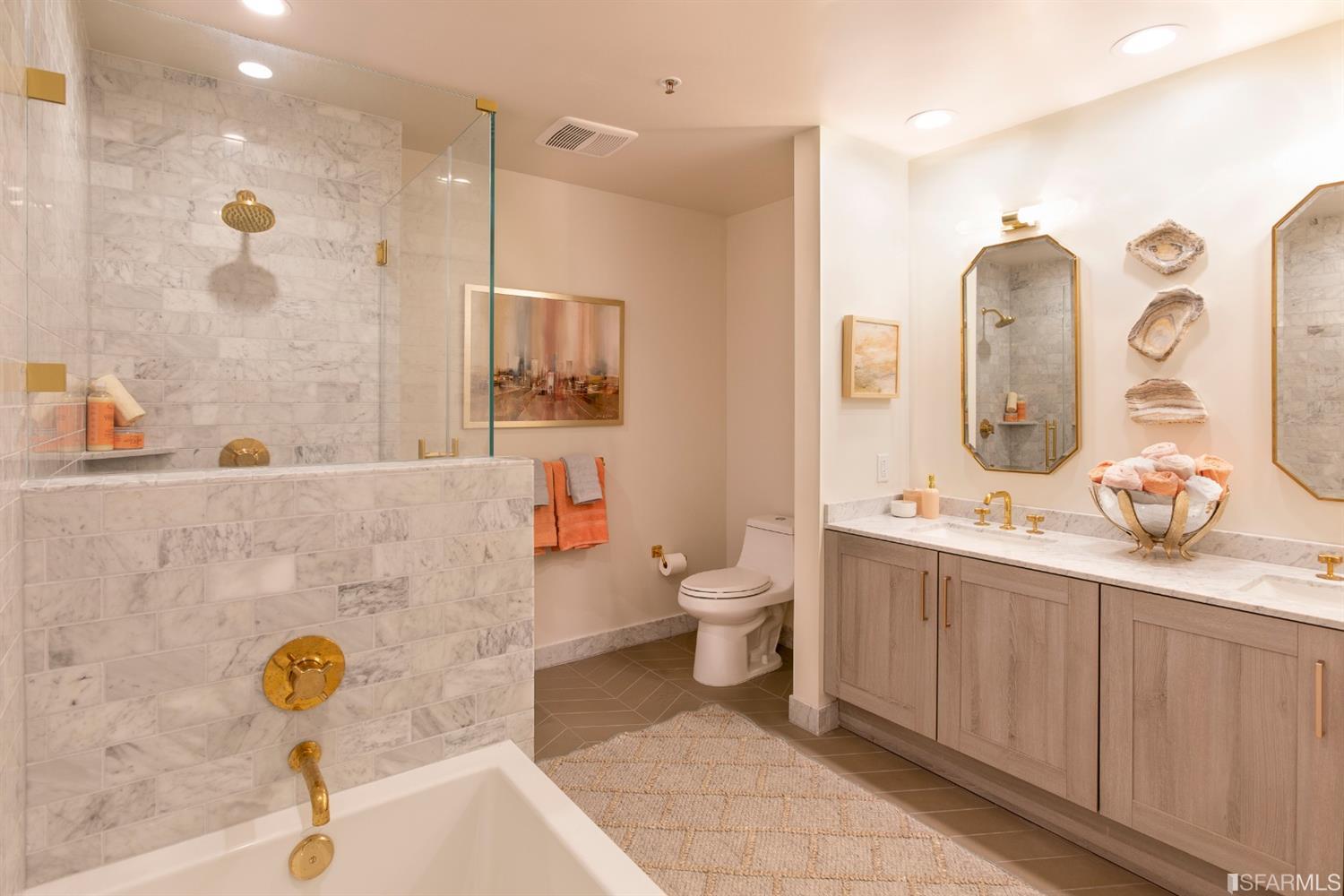 401 Harrison Street, Unit PH49A San Francisco, CA 94105 - Photo 7 of 14 a bathroom with a sink mirror and toilet