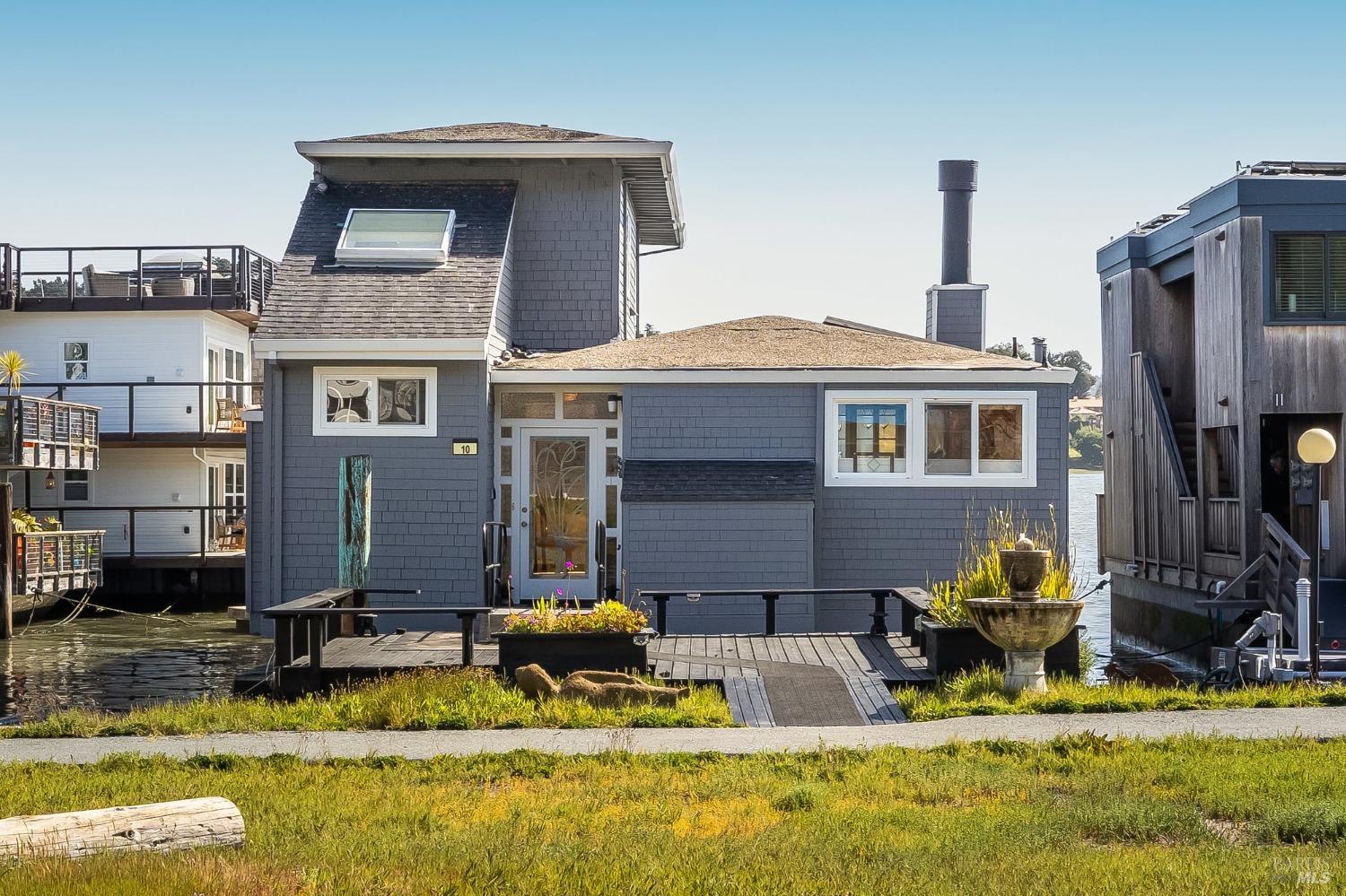 a backyard of a house with barbeque oven and a fountain