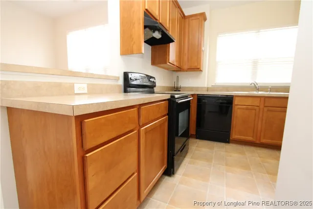 a kitchen with stainless steel appliances granite countertop a sink and a stove