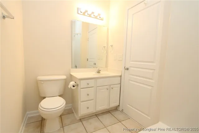 a bathroom with a toilet a sink and a mirror