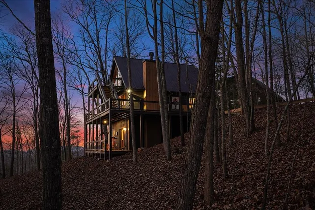 a backyard of a house with barbeque oven a table and chairs