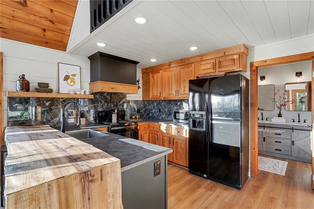 Undisclosed Address Morganton, GA 30560 - Photo 14 of 45 a kitchen with stainless steel appliances kitchen island granite countertop a refrigerator and a stove top oven