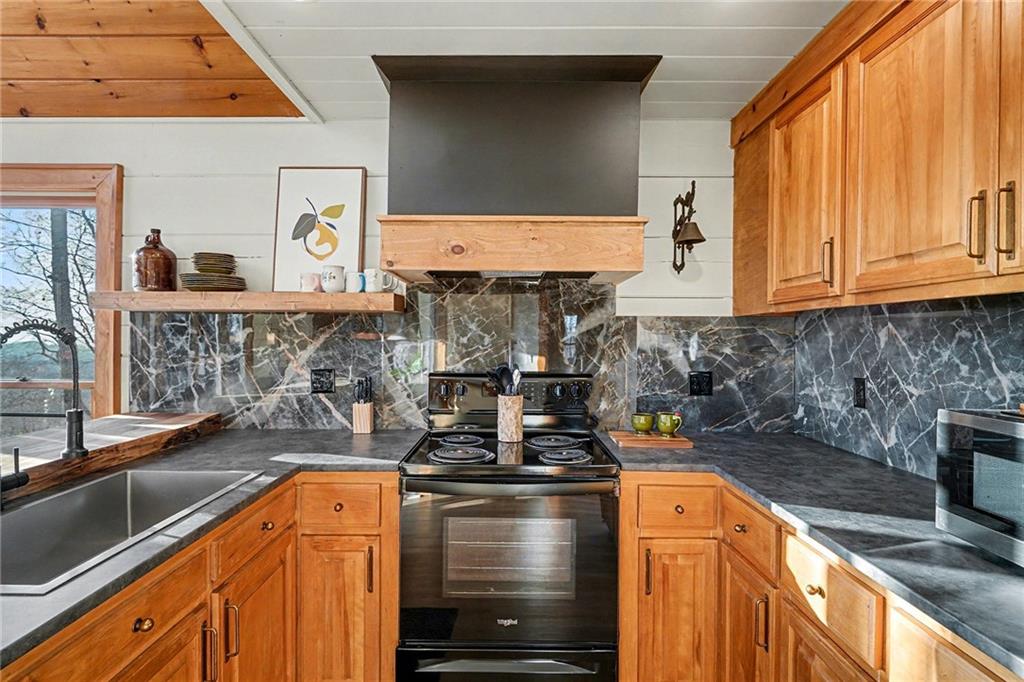 Undisclosed Address Morganton, GA 30560 - Photo 15 of 45 a kitchen with stainless steel appliances granite countertop a stove and a sink