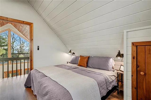 a backyard of a house with large trees and wooden fence