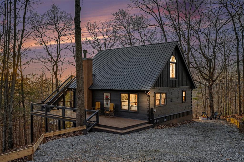 Undisclosed Address Morganton, GA 30560 - Photo 28 of 45 a backyard of a house with large trees and wooden fence