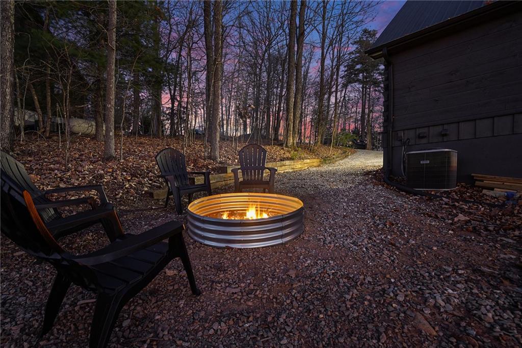 Undisclosed Address Morganton, GA 30560 - Photo 4 of 45 a backyard of a house with barbeque oven a table and chairs