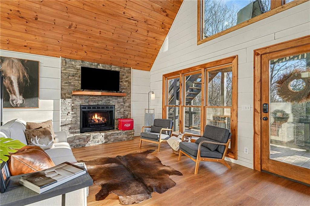 Undisclosed Address Morganton, GA 30560 - Photo 7 of 45 a living room with furniture a flat screen tv and a fireplace