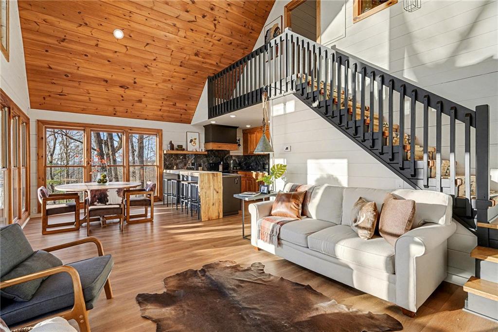 Undisclosed Address Morganton, GA 30560 - Photo 9 of 45 a living room with furniture stairs and a large window