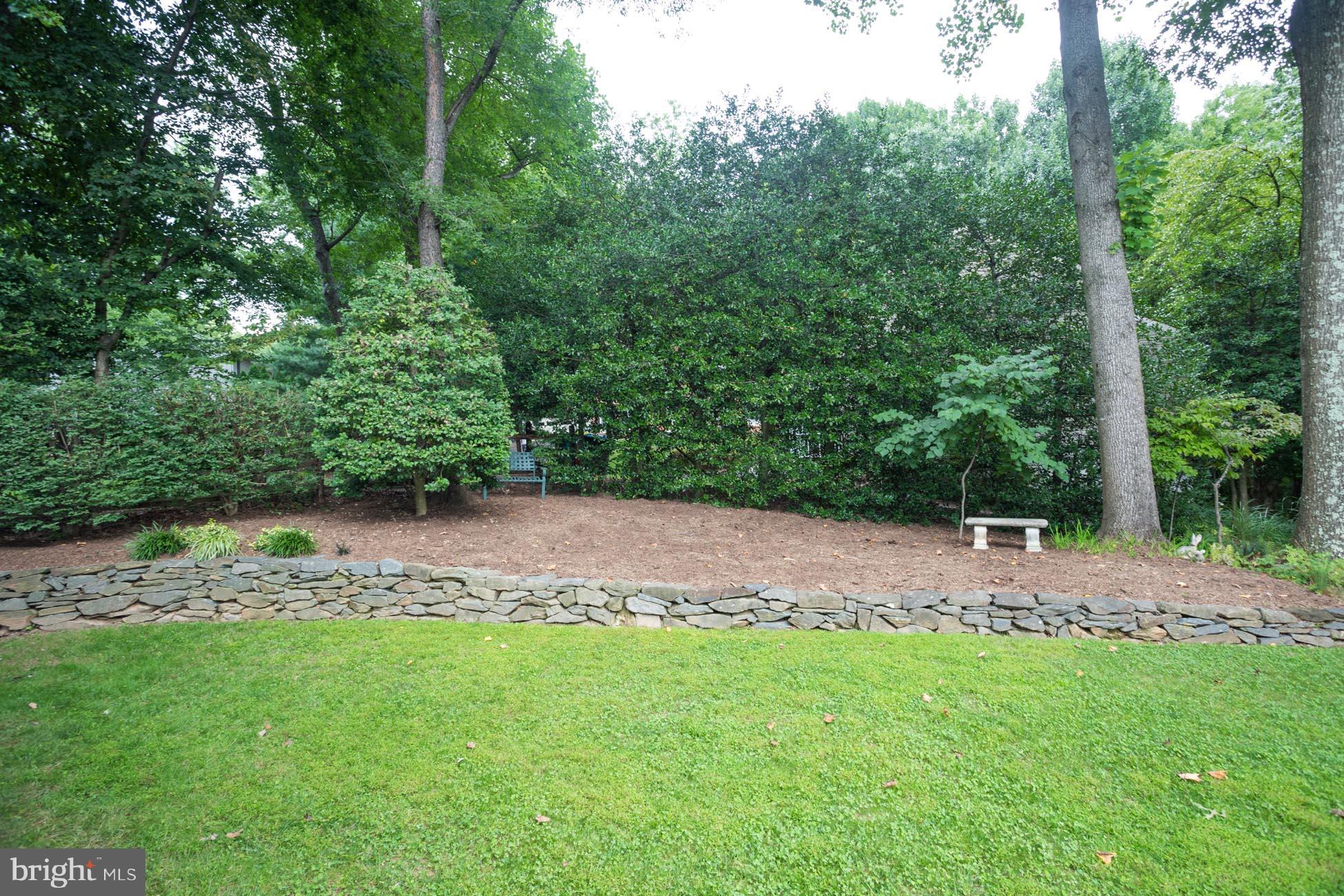 1325 Quail Ridge Drive Reston, VA 20194 - Photo 23 of 27 Peaceful parklike back yard with rock wall.