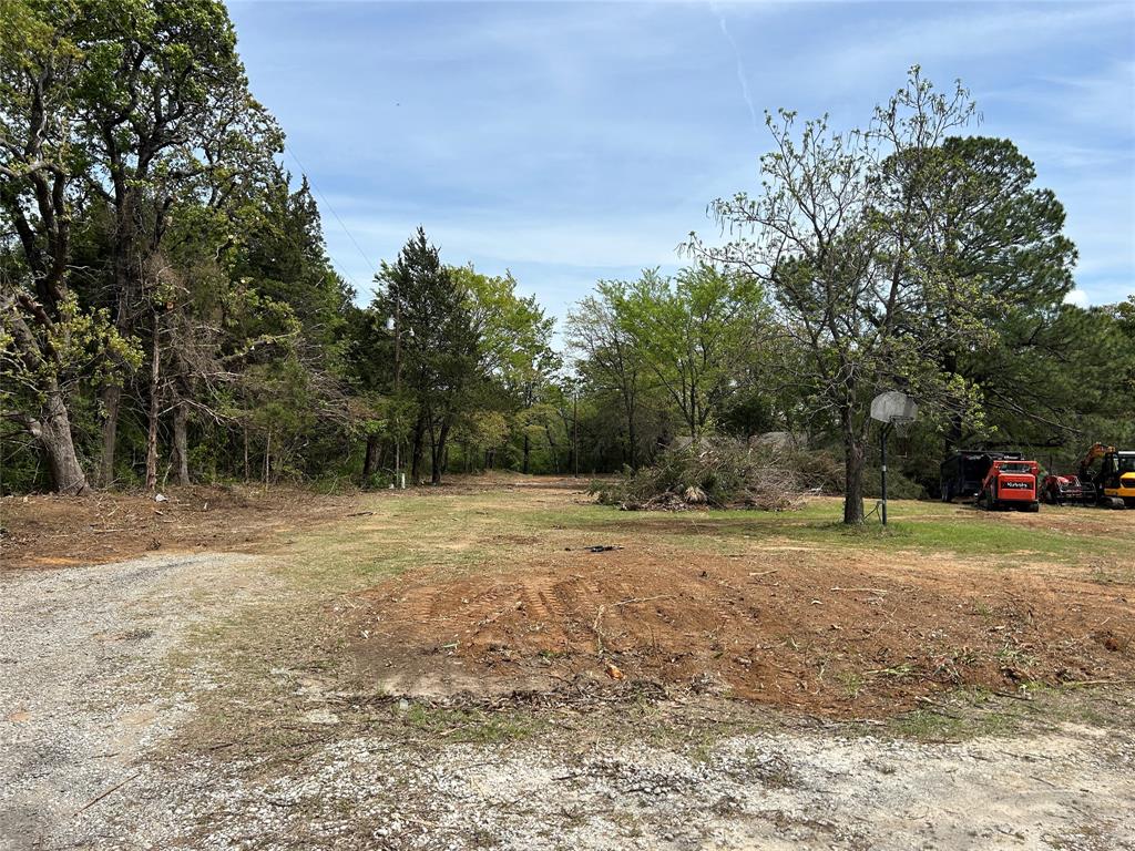 2112 Peterson Road Denison, TX 75021 - Photo 2 of 9 a view of a field with trees in the background