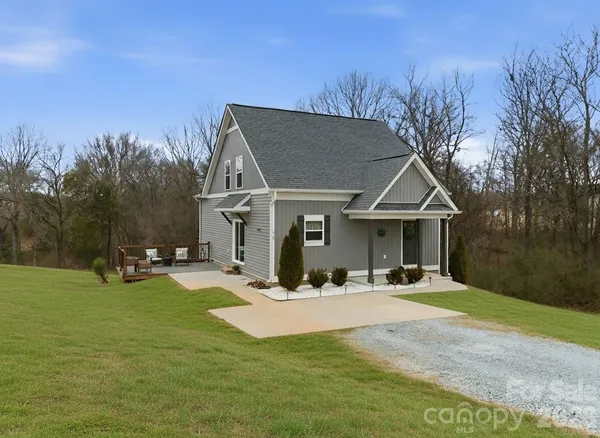a view of a house with yard and sitting area