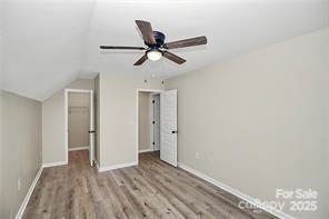 6109 Bunn Simpson Road Marshville, NC 28103 - Photo 14 of 17 a view of a livingroom with a hardwood floor and ceiling fan
