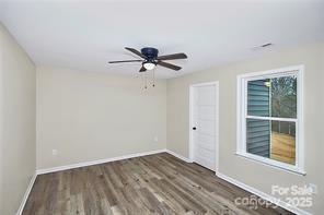 6109 Bunn Simpson Road Marshville, NC 28103 - Photo 7 of 17 a view of a room with a ceiling fan and wooden floor