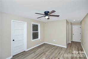 6109 Bunn Simpson Road Marshville, NC 28103 - Photo 8 of 17 a view of empty room with wooden floor and fan