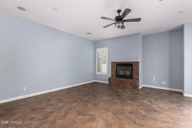 a view of a livingroom with a ceiling fan and fireplace