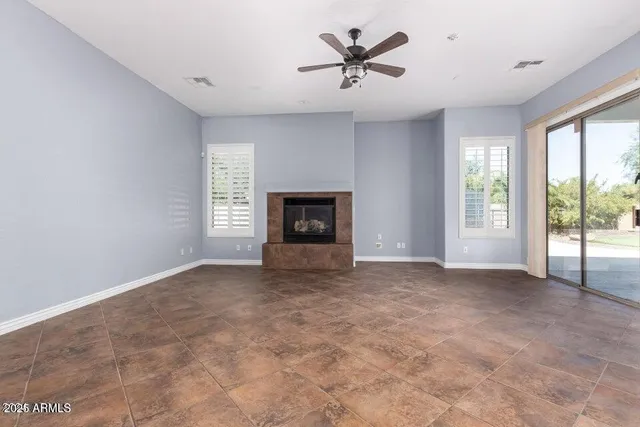 a view of an empty room with a fireplace and a window