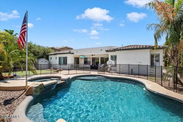 a view of a house with swimming pool and sitting area