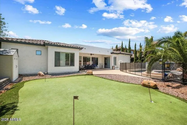 a swimming pool with outdoor seating and yard