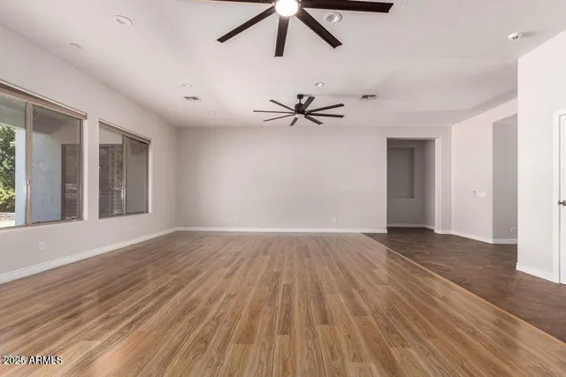 a view of a livingroom with a hardwood floor and a ceiling fan
