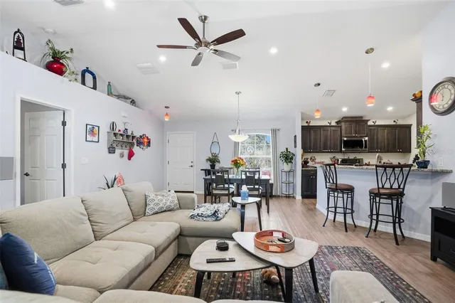 a kitchen with stainless steel appliances granite countertop a refrigerator stove and sink