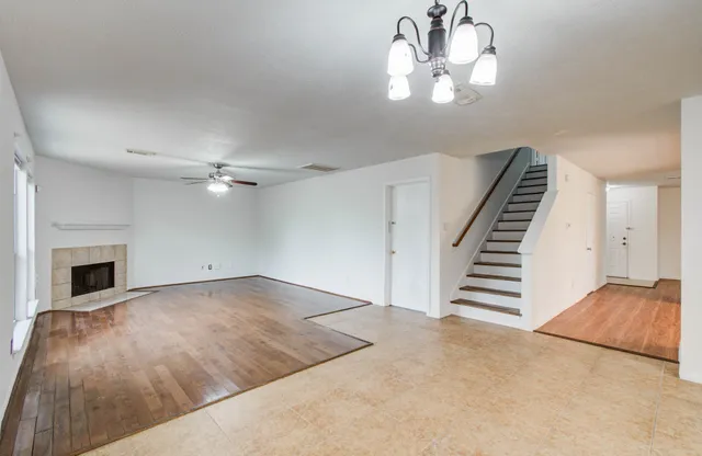 wooden floor in an empty room with a fireplace