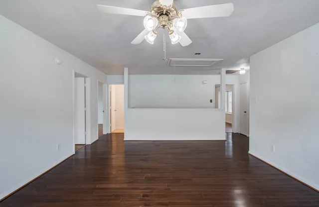 a view of an empty room with wooden floor
