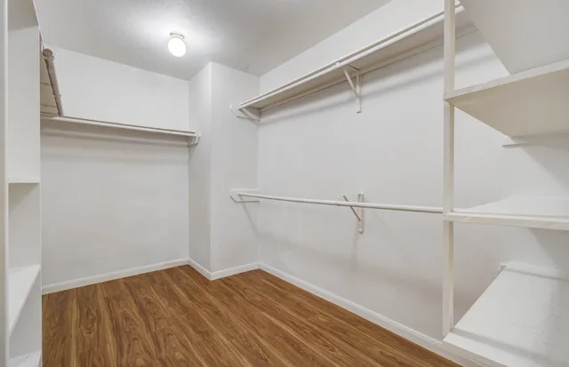 a view of a room with wooden floor