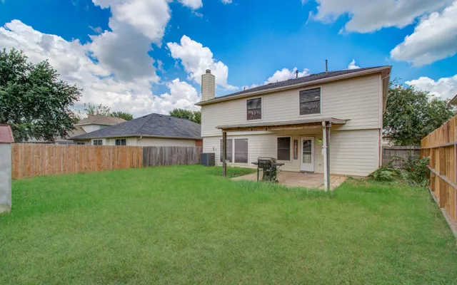 a view of a house with a yard and sitting area