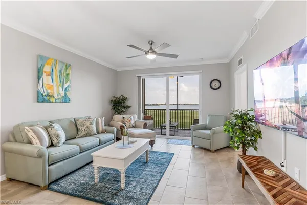 a living room with furniture and a large window