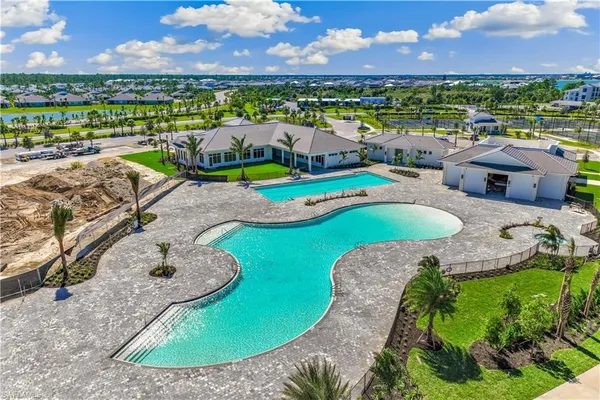a view of a swimming pool and lounge chairs