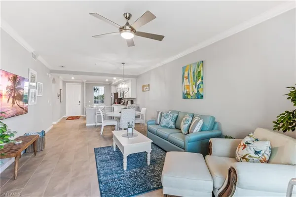 a living room with furniture and a chandelier