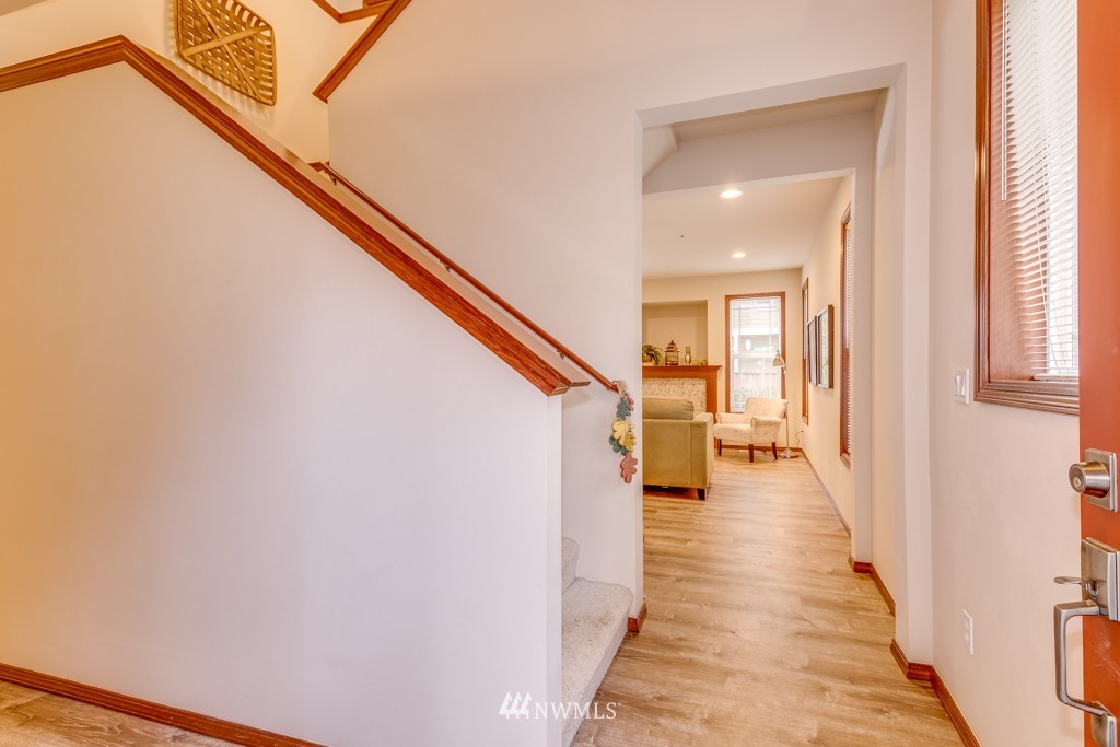 1048 215th Place Southeast Bothell, WA 98021 - Photo 3 of 30 a view of a hallway with wooden floor and staircase
