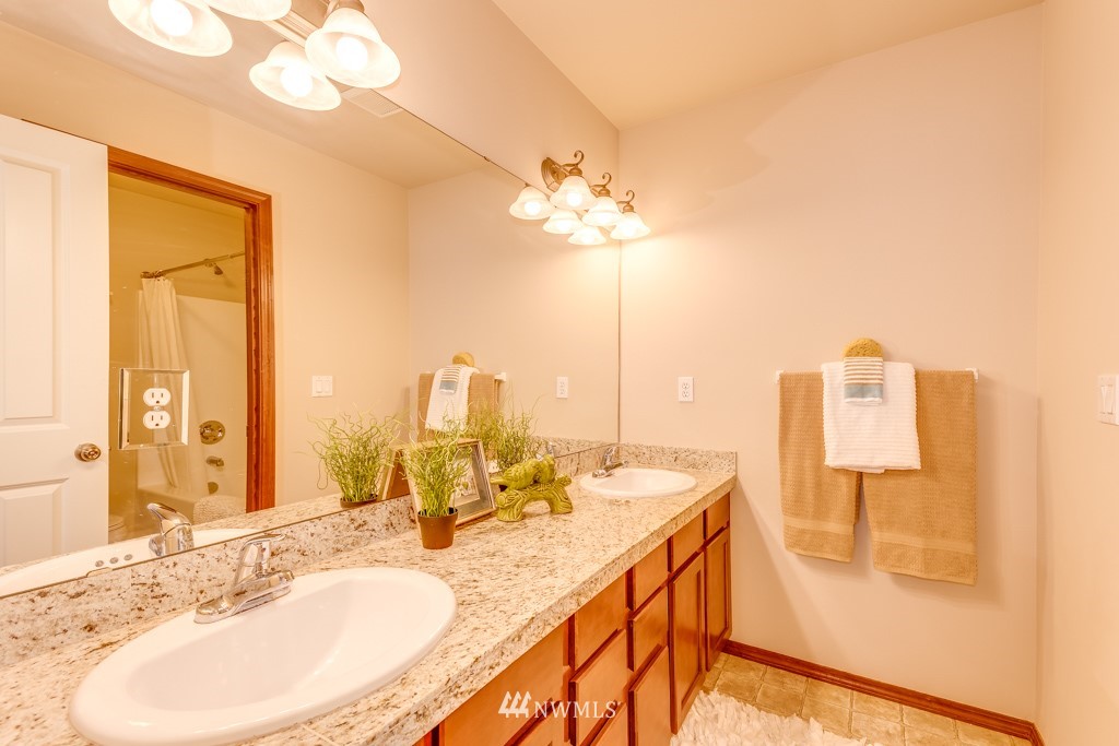 1048 215th Place Southeast Bothell, WA 98021 - Photo 22 of 30 a bathroom with a double vanity sink and a mirror