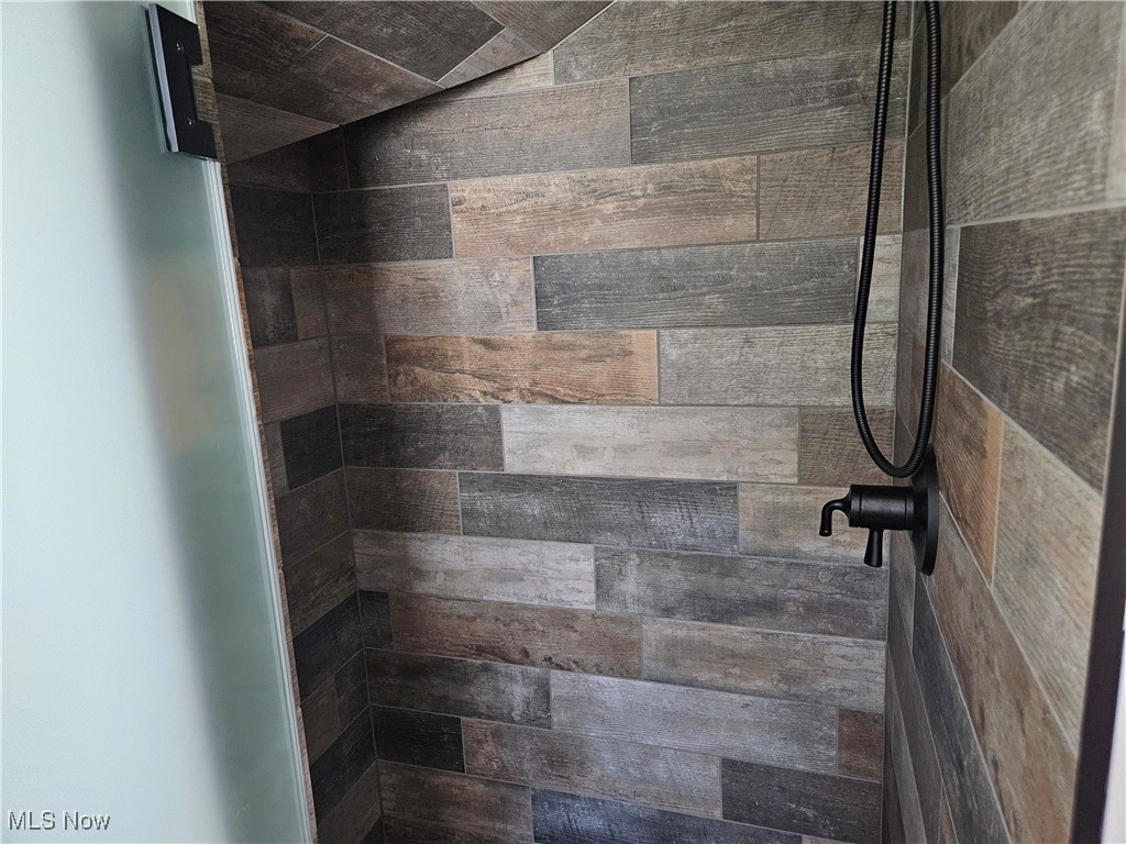 1180 North County Line Road Geneva, OH 44041 - Photo 16 of 33 Bathroom view of a tile shower