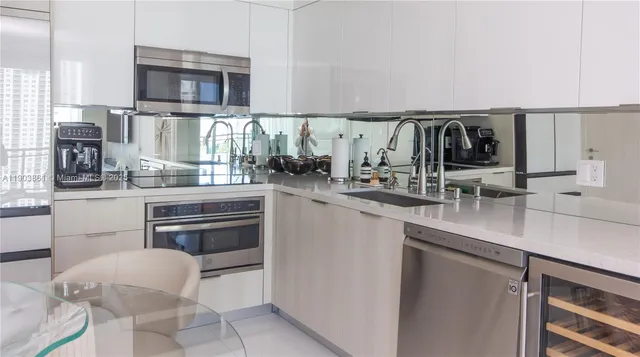 a kitchen with stainless steel appliances a sink and a stove