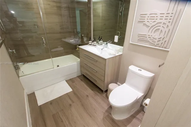 a bathroom with a sink mirror vanity and toilet