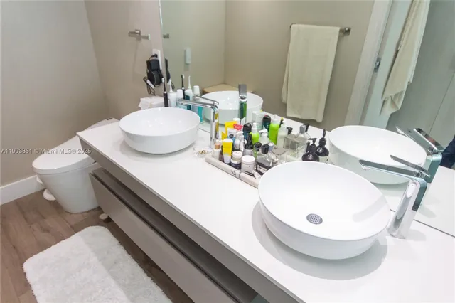 a bathroom with a double vanity sink and a mirror