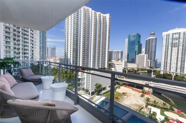 a living room with furniture and a floor to ceiling window