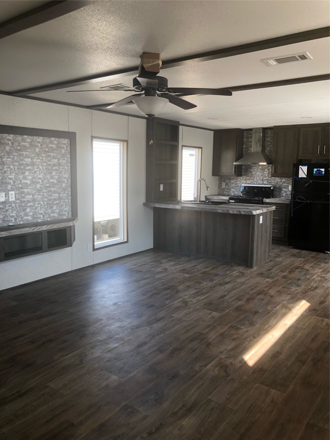10161 Pollard Road, Unit 2 Willis, TX 77318 - Photo 2 of 4 a kitchen with granite countertop a stove and a wooden floors