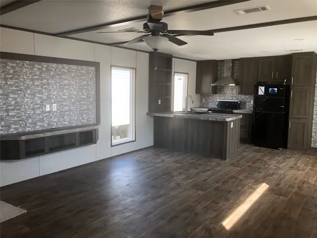 a kitchen with stainless steel appliances granite countertop a stove and a refrigerator