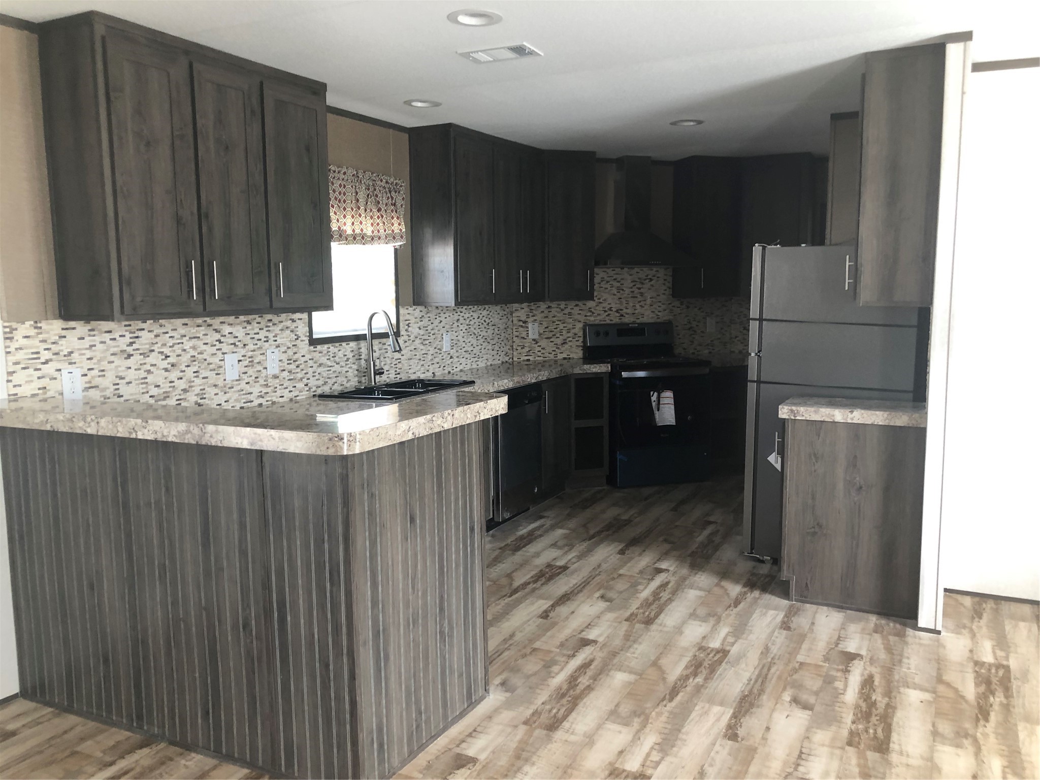 10161 Pollard Road, Unit 2 Willis, TX 77318 - Photo 4 of 4 a kitchen with stainless steel appliances granite countertop a sink refrigerator and cabinets