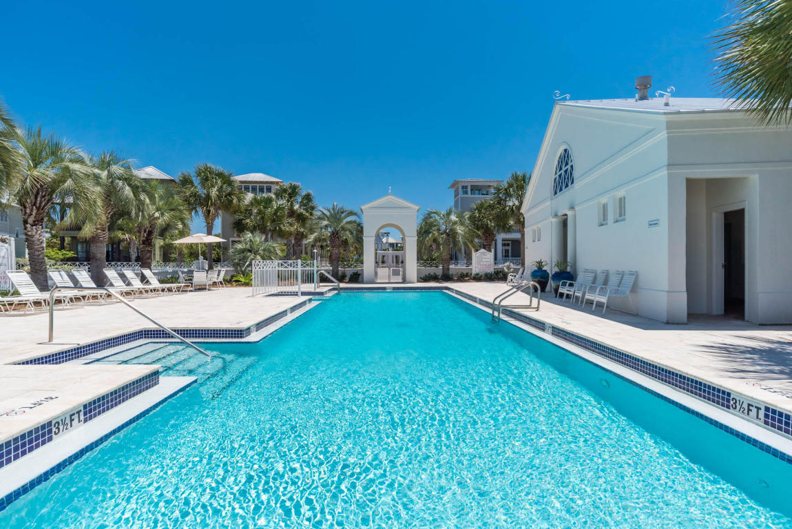 Undisclosed Address Panama City Beach, FL 32413 - Photo 15 of 20 a view of a house with swimming pool and a yard