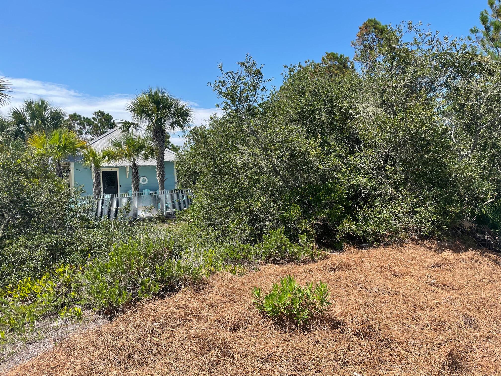 Undisclosed Address Panama City Beach, FL 32413 - Photo 4 of 20 a view of a house with a yard