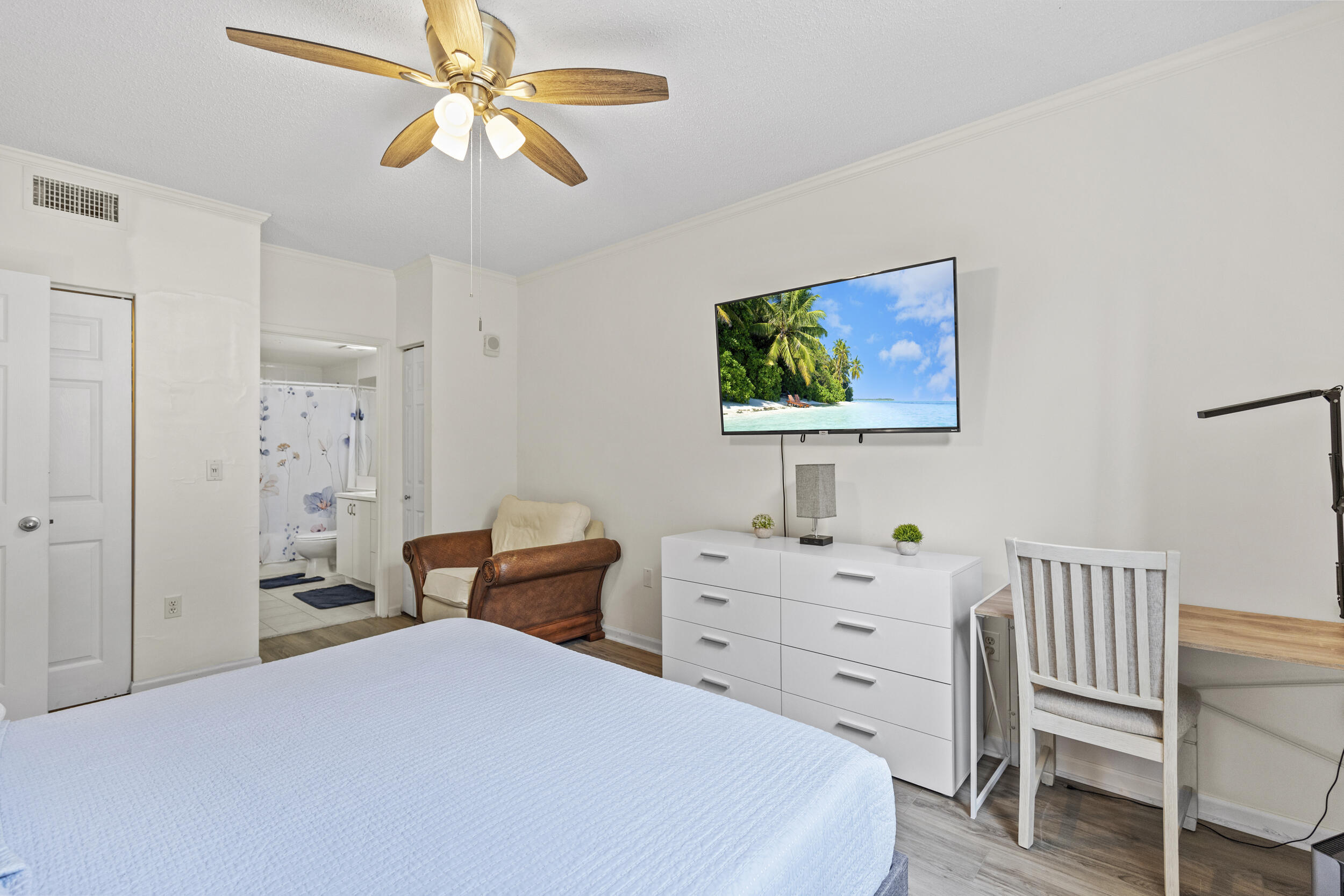 630 South Sapodilla Avenue, Unit 202 West Palm Beach, FL 33401 - Photo 14 of 31 a bedroom with a bed and a chandelier