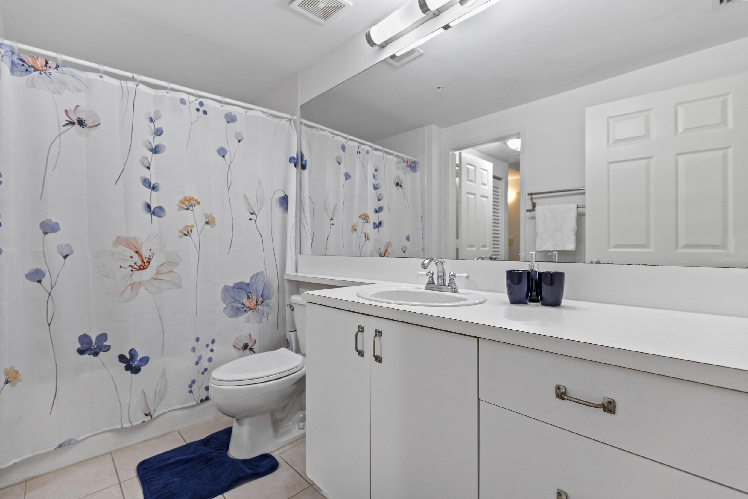 630 South Sapodilla Avenue, Unit 202 West Palm Beach, FL 33401 - Photo 15 of 31 a bathroom with a granite countertop sink toilet and a mirror