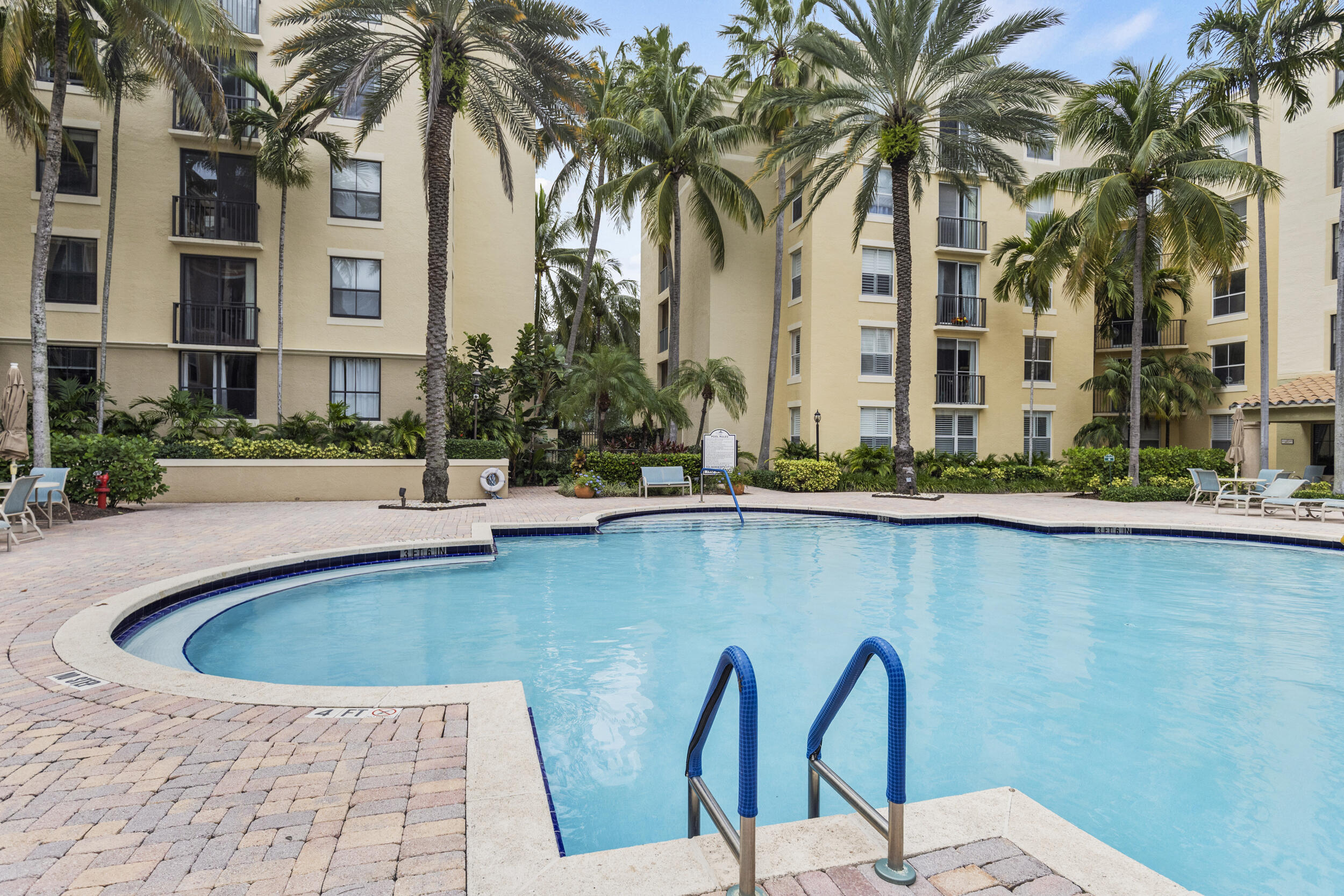 630 South Sapodilla Avenue, Unit 202 West Palm Beach, FL 33401 - Photo 17 of 31 a front view of a house with swimming pool and seating space