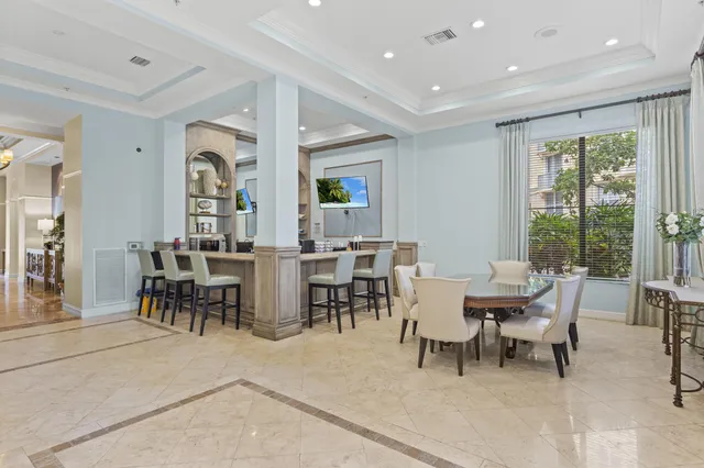a view of a dining room with furniture and a potted plant